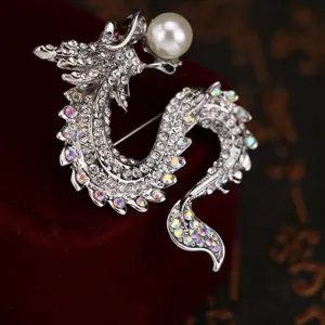 Sparkling crystal dragon brooch with pearl, silver tone metal lapel pin for suit or coat.