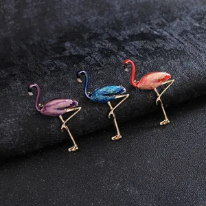 Exquisite detail view of colorful enamel flamingo brooches in purple, blue, and red styles.