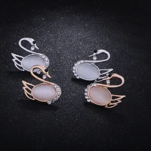 Elegant swan brooch pin featuring cat eye stone and sparkling rhinestones for women fashion.