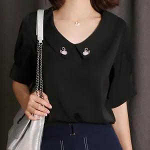 Exquisite swan brooch collar pin detail, elegant black blouse accessory for women fashion.