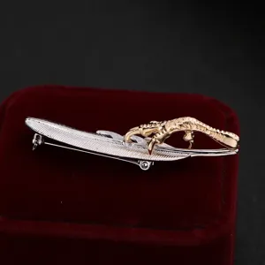 Detailed closeup of the exquisite eagle claw and feather brooch, stylish suit accessory.