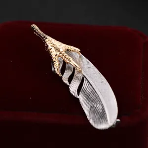 Exquisite eagle claw and feather brooch, metallic dual-tone suit pin, elegant fashion accessory.