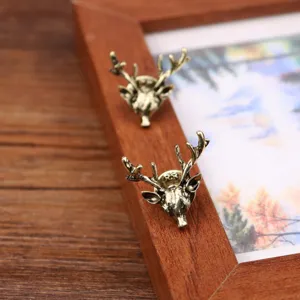Detailed shot of retro bronze deer head lapel pin, vintage metal collar brooch for men.