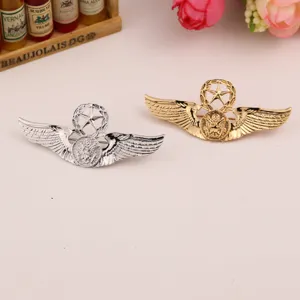 Detailed shot of retro gold and silver metal eagle wing brooches with military star design.