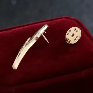 Gold feather brooch pin detail view, exquisite alloy suit accessory for men and women.
