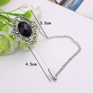 Vintage silver tone brooch pin with black stone and hanging chain for men and women fashion.