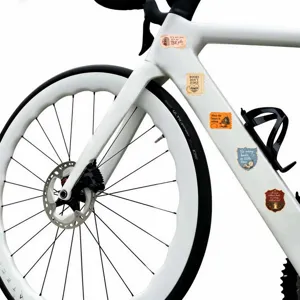 Vista dettagliata di adesivi con citazioni letterarie su telaio di bicicletta bianco per diari.