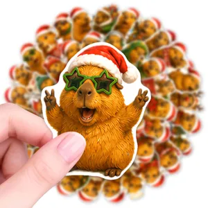 Closeup detail view of a cute Christmas capybara sticker featuring a festive hat and star glasses.