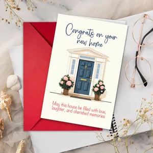 New home greeting card with floral house illustration and red envelope for housewarming gift.