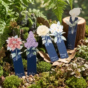 Close-up detail of botanical watercolor paper bookmarks featuring floral designs in natural moss.