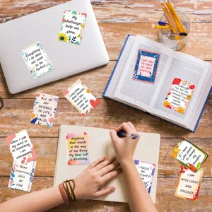 Detail shot of motivational affirmation cards with inspiring English quotes on desk.