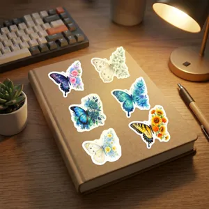 Detail shot of watercolor butterfly floral stickers displayed on a brown notebook surface.