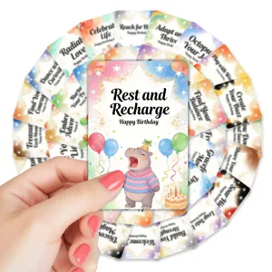 Close-up of cute watercolor birthday greeting card with hippo illustration and motivational text.