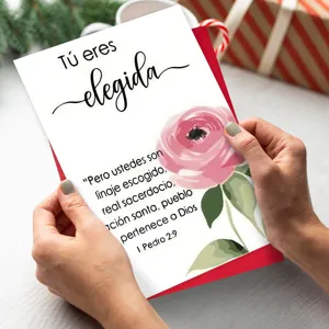Closeup of inspirational greeting card with floral design and Bible verse text, elegant.