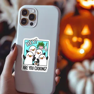 Cute cartoon penguin sticker detail on phone case, fun emoji design for DIY decoration.