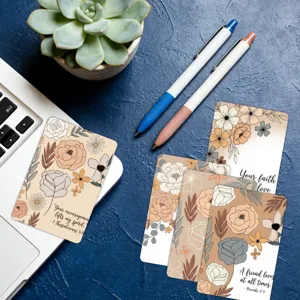 Detail view of floral affirmation cards with motivational scripture on blue surface.