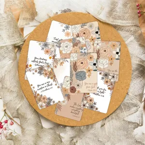 Close-up detail shot of floral affirmation cards with inspirational quotes on cork board.