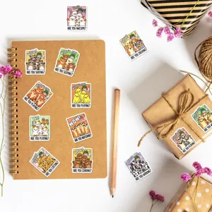 Cute cartoon animal stickers detail on notebook and gift box, perfect for journal and craft decor.