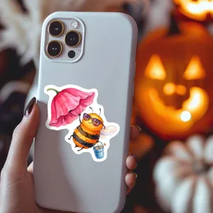 Cute watercolor bee sticker detail displayed on phone case, vibrant cartoon illustration.