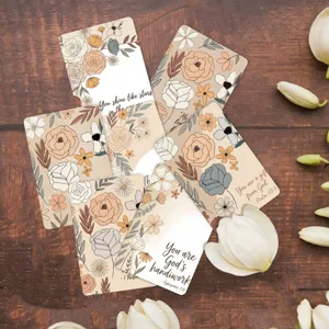 Close-up detail of floral affirmation cards with inspirational quotes and botanical designs.