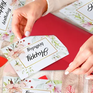 Close up detail of greeting card with floral watercolor design and envelope, perfect for event.