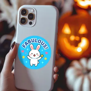 Close-up detail of cute cartoon bunny sticker on protective phone case with lovely design.