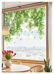 Detail shot of green leaf window sticker on glass, showing forest pattern and shading.