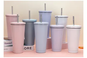 Close-up of double-wall stainless steel tumbler cups in assorted pastel colors