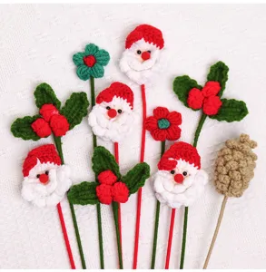 Detailed view of handmade knitted Santa Claus and pinecone Christmas decorations