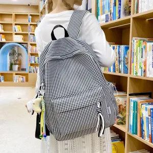 Stylish black and white checkered backpack for women, a perfect choice for school or travel.