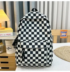 Detailansicht eines schwarz-weißen Schachbrett-Rucksacks aus Segeltuch in einem Zimmer.