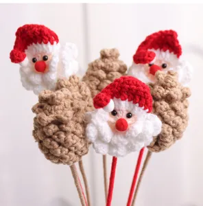 Detailed view of handmade crochet Santa Claus and pinecone Christmas decoration bouquet