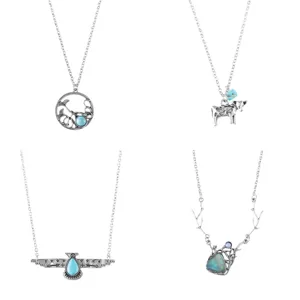 Detailed view of vintage bohemian alloy necklaces featuring turquoise stones, cow and ginkgo motifs.