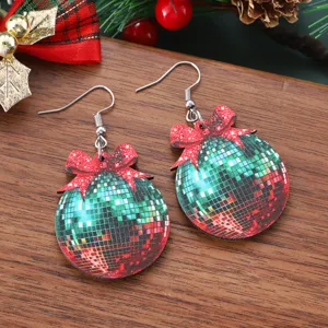 Christmas wooden disco ball earrings detail, featuring festive red and green bow pendant.