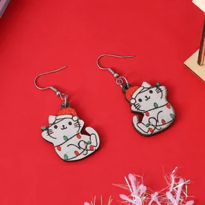 Primo piano dettagliato di orecchini di gatto di Natale in legno con cappello da Babbo Natale.