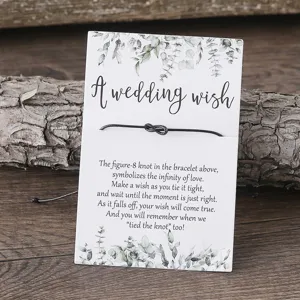 Black braided string wish bracelet with eucalyptus leaf wedding card detail jewelry.