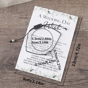 Adjustable black braided cord bracelet with heart charm on wedding wish display card detail.