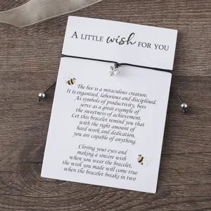 Woven black cord wish bracelet featuring a cute silver bee pendant on a message greeting card.