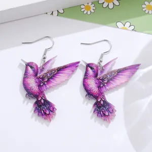 Detailed close-up of vibrant purple hummingbird acrylic drop earrings, lightweight summer style.