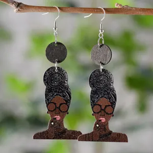Close-up detail of African queen wooden dangle earrings, featuring ethnic portrait and natural texture.