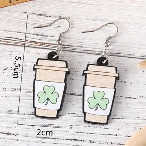 Nahaufnahme Detail von hölzernen Kaffeetasse Kleeblatt Ohrhängern, St. Patricks Day Schmuck.
