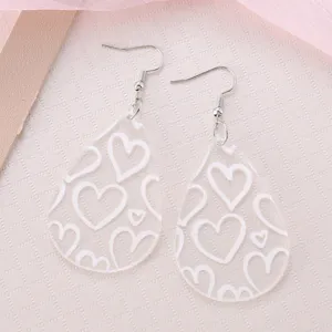 Clear acrylic teardrop earrings with white heart pattern, cute dangling hook earrings for women.