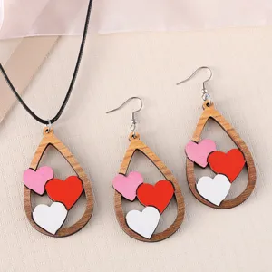 Detailed shot of wooden teardrop necklace and earrings set with cute heart designs.
