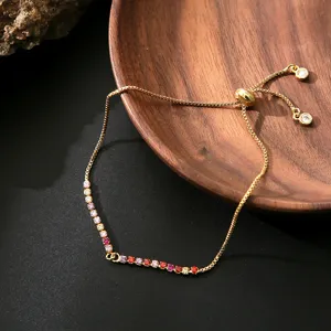 Adjustable gold plated box chain bracelet featuring colorful cubic zirconia crystals and slider.