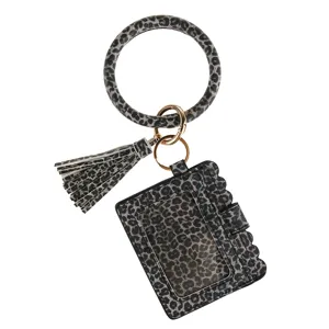 Leopard print PU leather wristlet bracelet keychain card holder coin purse with tassel detail.