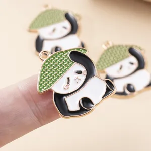 Close up of cute cartoon panda alloy pendant with green straw hat, perfect DIY charm detail.