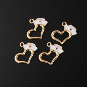 Detailed close-up of gold-tone alloy enamel nurse hat and heart shaped DIY charms.