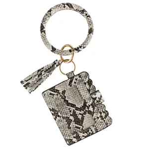 Close-up detail of snakeskin PU leather wristlet key ring with card holder and tassel pendant.