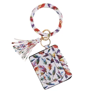 Detail view of PU leather wristlet card holder keychain with colorful feather print and tassel.