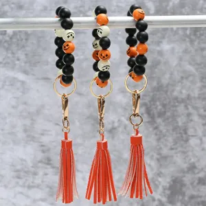 Halloween wooden bead wristlet keychain with leather tassel, colorful festival accessory key ring.